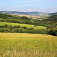 Krajina v okolí Vrboviec, v pozadí hraničný hrebeň s vrchmi Kobyla, Stráň a sedlom Tri kamene